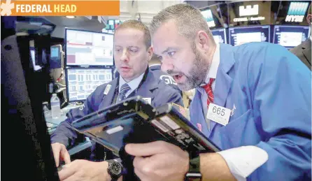  ?? — Reuters ?? Traders work on the floor of the New York Stock Exchange (NYSE) in New York.
