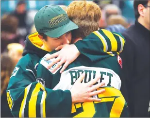  ?? CP PHOTO ?? Mourners comfort each other during a vigil at the Elgar Petersen Arena, home of the Humboldt Broncos, to honour the victims of a fatal bus accident in Humboldt, Sask. on Sunday.