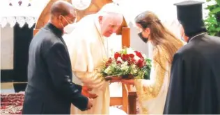  ?? AP PHOTO/ANDREW MEDICHINI ?? Pope Francis is welcomed upon his arrival at the Sayidat al-Nejat (Our Lady of Salvation) Cathedral on Friday, in Baghdad.