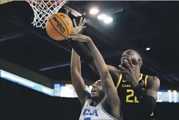  ?? Ashley Landis Associated Press ?? of UCLA has his shot blocked by Franck Kepnang of Oregon during the first half.