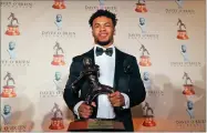  ?? AP PHOTO BY LM OTERO ?? Heisman Trophy winner quarterbac­k Kyler Murray posses with the Davey O’brien football award he received in Fort Worth, Texas, Monday, Feb. 18.