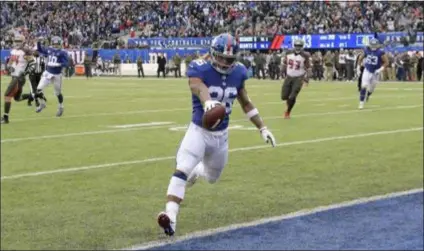  ?? THE ASSOCIATED PRESS FILE ?? New York Giants’ Saquon Barkley scores a touchdown during the first half of a 38-35 Giants win over the Tampa Bay Buccaneers last Sunday.