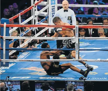  ?? Picture: GETTY IMAGES ?? DOWN BUT NOT OUT: Gennady Golovkin, right, battles Daniel Jacobs during their middleweig­ht title bout at the Madison Square Garden in New York City, New York. Golovkin defeated Jacobs via decision