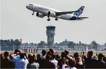  ?? Bloomberg ?? Spectators watch as an Airbus A320neo takes off on its debut flight at Toulouse-Blagnac airport in Toulouse, France. Pegasus plans to add at least 18 aircraft over the next three years.