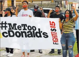  ?? Janet Mcconnaugh­ey ?? The Associated Press Current and former Mcdonald’s employees wear tape with #Metoo over their mouths at a protest in New Orleans on Tuesday.