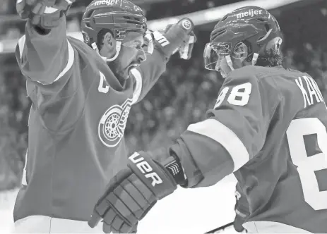  ?? PAUL SANCYA/AP ?? Red Wings right wing Patrick Kane, right, celebrates his goal against the Colorado Avalanche with Dylan Larkin during overtime at Little Caesars Arena on Thursday.