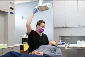  ?? NEWS PHOTO EMMA BENNETT ?? Dr. Chris Baba checks on a patient at Sun City Dental. On Wednesday, Health Minister Sarah Hoffman announced a new dental fee guide in Alberta.