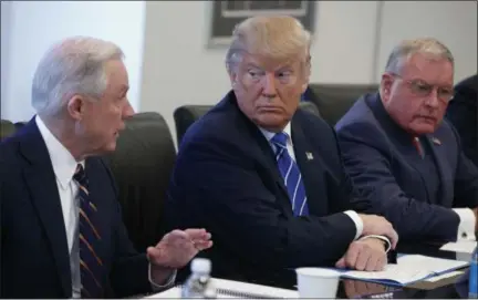  ?? EVAN VUCCI — ASSOCIATED PRESS ?? Republican presidenti­al candidate Donald Trump, center, and retired Gen. Keith Kellogg, right, listen as Sen. Jeff Sessions, R-Ala., speaks during a national security meeting with advisors at Trump Tower, Friday in New York.