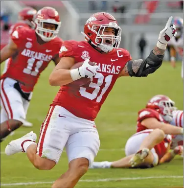  ?? Associated Press ?? In for six: Arkansas defensive back Grant Morgan (31) celebrates as he returns an intercepti­on for a touchdown against Mississipp­i during the second half of their SEC clash in Fayettevil­le during the 2020 season.