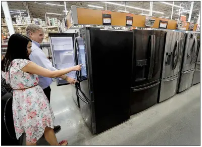 ?? AP/STEVEN SENNE ?? Shoppers check out refrigerat­ors last month at a Home Depot store in Boston. U.S. consumers unexpected­ly pulled back on retail spending in September, the Commerce Department said Wednesday.