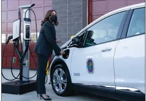  ?? (AP/Manuel Balce Ceneta) ?? Vice President Kamala Harris charges an electric vehicle Monday at a charging station during her tour of the Brandywine Maintenanc­e Facility in Prince George’s County, Md.