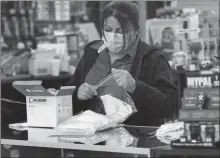  ?? Los Angeles Times/tns ?? Teresa Olivas prepares single face mask bags at Prep and Save store in Upland on March 17.