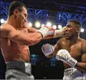  ?? RICHARD HEATHCOTE/GETTY IMAGES ?? Anthony Joshua (right) defeated Wladimir Klitschko in the IBF, WBA and IBO heavyweigh­t title bout April 29, 2017. A fight with Joshua is Tyson Fury’s ultimate goal.