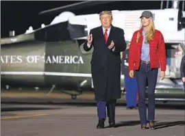  ?? Evan Vucci Associated Press ?? PRESIDENT TRUMP arrives at a campaign rally for Republican Sens. Kelly Loeff ler, right, and David Perdue at Dalton Regional Airport in Dalton, Ga.