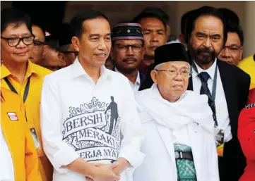  ??  ?? Widodo (left) and Amin (right) meet supporters in Jakarta, Indonesia.