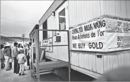  ??  ?? REFUGEES WAIT their turn outside a trailer to sell gold. Some f led the country with gold, figuring their paper money would be worthless.