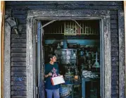  ?? Michael Ciaglo / Houston Chronicle ?? Manager Gloria Milburn takes inventory inside Chloe’s, one of three stores damaged in an October fire.