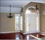  ??  ?? The entryway and formal dining area are illuminate­d by coordinati­ng light  xtures.