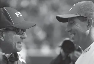  ?? File, Rainier Ehrhardt / AP ?? FSU coach Jimbo Fisher (left) and Clemson coach Dabo Swinney will play in rivalry games this weekend.