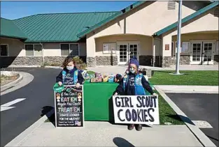  ?? COURTESY OF DAVID WATKINS ?? Juliana Whittier and Brenna Watkins, Daisy scouts from Troop 8014, were found selling cookies at the Golden Hills Community Service District.