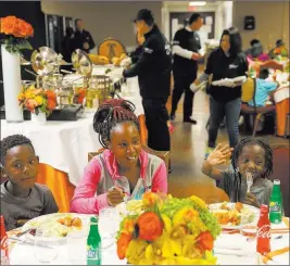  ?? K.M. Cannon ?? Las Vegas Review-journal @Kmcannonph­oto Todiah Coleman and her sons Jaurice Lee, 9, and Tarrice Lee, 5, enjoy Thanksgivi­ng dinner catered by Wynn Las Vegas at the Shade Tree shelter for homeless women and children Wednesday.