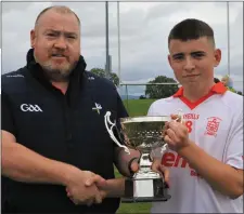  ??  ?? Padraic Downey receives the Argus U16 Division 3 trophy from Kevin Gordon, Louth Minor Board. Pictures: Kieran Carr