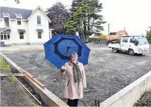  ?? PHOTO: PETER MCINTOSH ?? Rain, hail or shine . . . Columba College principal Pauline Duthie stands on the constructi­on site of the school’s new $150,000 allweather sports turf.