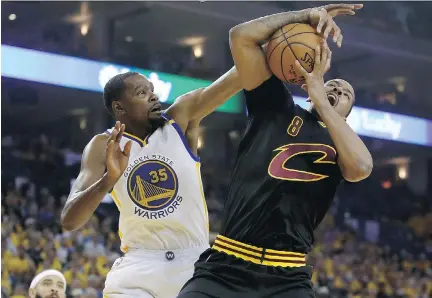  ?? EZRA SHAW/GETTY IMAGES ?? Golden State Warriors forward Kevin Durant, left, seen battling Cleveland Cavaliers forward Channing Frye during Game 2 of the NBA Finals on Sunday in Oakland, Calif., has been dominant this post-season. He put up a game-high 33 points in Sunday’s...