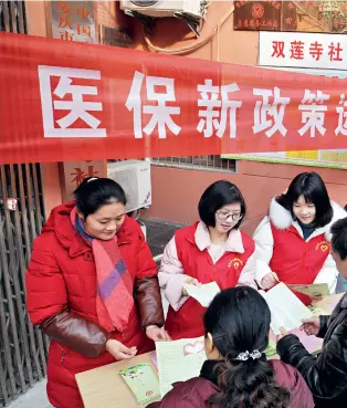  ??  ?? New health insurance policy is publicized in a community in Anqing, Anhui Province.
