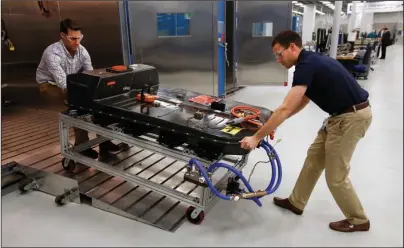  ?? The Associated Press ?? BATTERY PACK: In this Nov. 4, 2016, file photo, a Chevrolet Bolt EV battery pack is removed for testing after undergoing charging and dischargin­g cycles at General Motors Warren Technical Center’s Advanced Energy Center in Warren, Mich. If U.S. consumers ever ditch fuel burners for electric vehicles, then the United Auto Workers union is in trouble. Gone would be thousands of jobs at engine and transmissi­on plants across the industrial Midwest, replaced by smaller workforces at squeaky-clean mostly automated factories that mix up chemicals to make batteries.