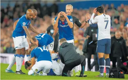  ?? Photo / Getty Images ?? Opponents and teammates alike were left distraught after Andre Gomes’ serious ankle injury.