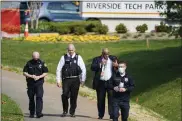  ?? JULIO CORTEZ - THE ASSOCIATED PRESS ?? Police walk near the scene of a shooting at a business park in Frederick, Md., Tuesday, April 6, 2021.