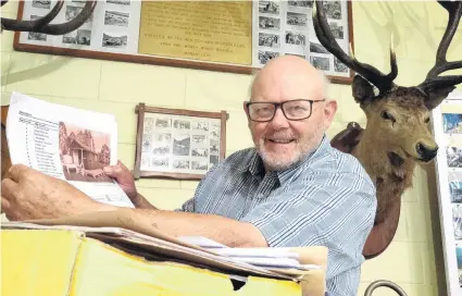  ?? PHOTO: RUBY HEYWARD ?? Deery me . . . Looking through hut plans at the New Zealand Deerstalke­rs Associatio­n North Otago branch hall in Oamaru is hut project coordinato­r Barry Wilson.