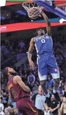  ?? MATT SLOCUM/AP ?? The Philadelph­ia 76ers’ Tyrese Maxey, right, dunks the ball past the Cleveland Cavaliers’ Lamar Stevens on Friday in Philadelph­ia.