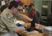  ?? KRISTI GARABRANDT — THE NEWS-HERALD ?? Kalvin Galletti of Boy Scout Troop 289 of Wickliffe carves one of the hams Dec. 25 to be served at the Willoughby United Methodist Church Community Christmas Dinner.