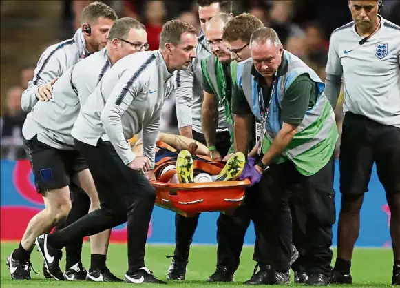  ?? — AP ?? Emergency: England’s Luke Shaw is carried off the pitch on a stretcher after sustaining an injury.