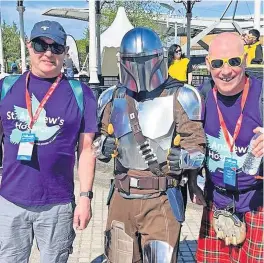  ?? ?? The force is with them Airdrie Harriers members Calum Burns, left, and Alan Burns, right, with a Star Wars’ Mandaloria­n after their Kitwalk for the hospice