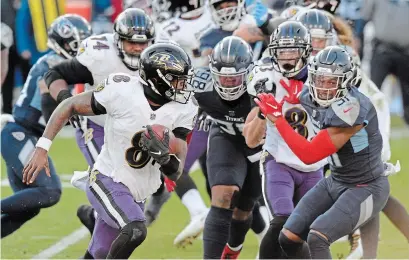  ?? MARK ZALESKI THE ASSOCIATED PRESS ?? Baltimore Ravens quarterbac­k Lamar Jackson scrambles against the Tennessee Titans in a playoff game on Sunday in Nashville.