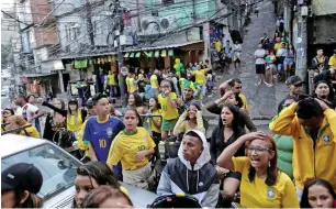  ??  ?? FOOTBALL ABOVE ALL: Fans drop everything to watch the broadcast of the FIFA World Cup Group E soccer match between Brazil and Switzerlan­d at Rocinha slum in Rio de Janeiro, Brazil June 17, 2018