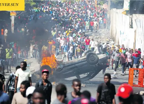  ?? DIEU NALIO CHERY / THE ASSOCIATED PRESS ?? Protesters demanding the resignatio­n of Haitian President Jovenel Moise overturned cars and blocked major highways across the Caribbean nation, trapping more than 100 Canadian tourists and aid workers.