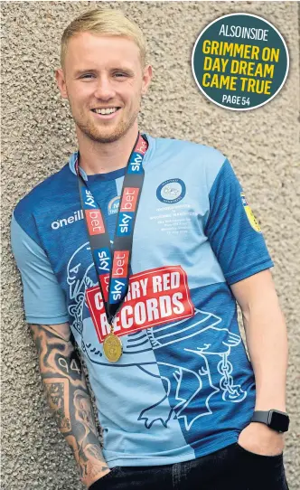  ?? Photograph by Kath Flannery ?? ALL SMILES: Jack Grimmer at home in Aberdeen with his medal.