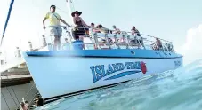  ??  ?? FLIPPIN’ BRILLIANT: Playful dolphins were easy to spot on a tour with Island Time Sailing