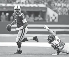  ?? THOMAS J. RUSSO/USA TODAY SPORTS ?? Jacoby Brissett, rolling out of the pocket against Texans defensive end J.J. Watt, has thrown 14 TD passes this season for the Colts.