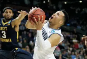  ?? CHARLES KRUPA — THE ASSOCIATED PRESS ?? In this March 23, 2018, file photo, Villanova’s Jalen Brunson, right, drives against West Virginia’s James Bolden (3) during the first half of an NCAA men’s college basketball tournament regional semifinal, in Boston. Brunson, The Associated Press...