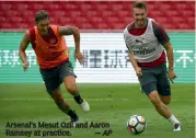  ?? — AP ?? Arsenal’s Mesut Ozil and Aaron Ramsey at practice.