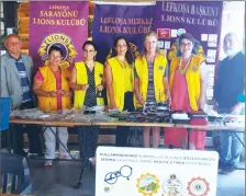  ??  ?? Lions Club leaders from Lefkoşa with the glasses they collected during a five-month campaign