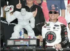  ?? NICK WASS — THE ASSOCIATED PRESS ?? Kevin Harvick, right, poses with the trophy in Victory Lane after he won the NASCAR Cup Series auto race, Sunday at Dover Internatio­nal Speedway in Dover, Del.