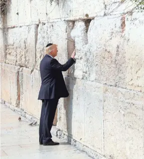  ?? POOL PHOTO BY RONEN ZVULUN ?? President Trump became the first sitting U.S. president to touch the Western Wall, Judaism’s holiest prayer site, in East Jerusalem’s Old City on May 22. Israel’s claim to the area is disputed by Palestinia­ns.