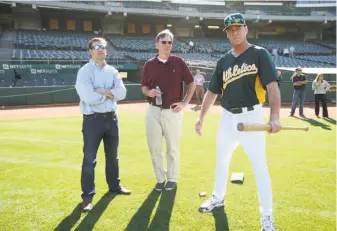  ?? Michael Zagaris / Getty Images 2012 ?? In 2012, then-assistant general manager David Forst, general manager Billy Beane and manager Bob Melvin watch then-prospect Addison Russell work out at the Oakland Coliseum.