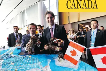  ?? MAPLE LEAF STRATEGIES ?? Prime Minister Justin Trudeau and Alibaba Group founder Jack Ma hold Clearwater lobster in Hangzhou, China, last year. The Liberal government announced that it will “enhance access” to the surf clam fishery for Indigenous groups, which means that Clearwater’s clam business stands to shrink by a quarter, John Ivison writes.